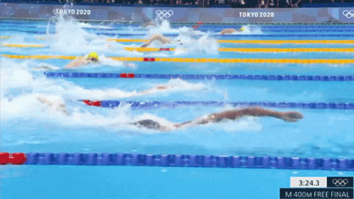 A Group Of Swimmers Are Swimming In A Pool At The Tokyo 2020 Olympics .. GIF