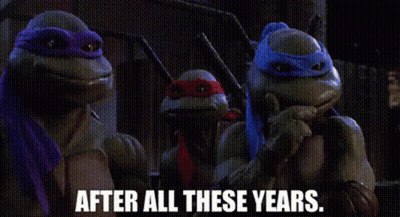 A Group Of Teenage Mutant Ninja Turtles Are Standing Next To Each Other And Talking . GIF