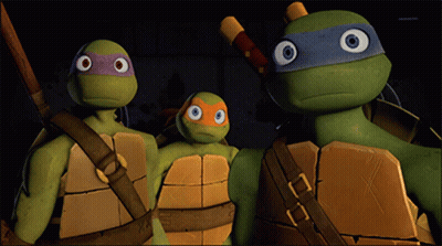 A Group Of Teenage Mutant Ninja Turtles Standing Together GIF