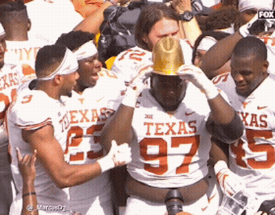 A Group Of Texas Football Players Are Celebrating GIF