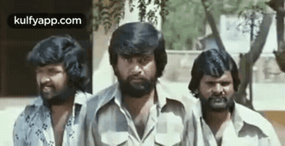 A Group Of Three Men With Beards Are Standing Next To Each Other And Smiling . GIF