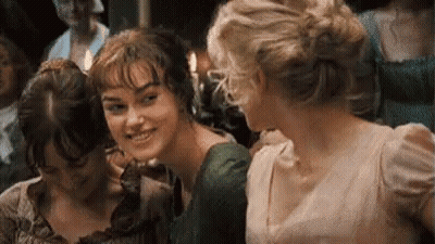 A Group Of Three Women Are Standing Next To Each Other In A Room And Smiling . GIF
