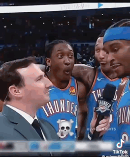 A Group Of Thunder Basketball Players Are Talking To A Reporter . GIF