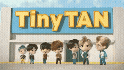 A Group Of Tiny Tan Characters Standing In Front Of A Building GIF