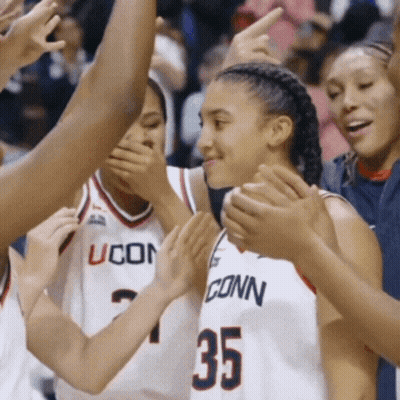 A Group Of Uconn Basketball Players Are Clapping Together GIF