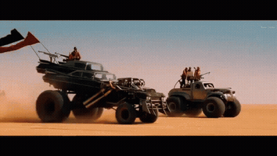 A Group Of Vehicles Are Driving Through The Desert GIF