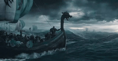 A Group Of Vikings Are Riding On The Back Of A Boat In The Ocean . GIF