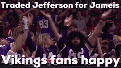 A Group Of Vikings Fans Are Raising Their Arms In The Air . GIF