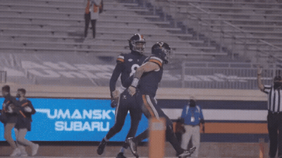 A Group Of Virginia Tech Football Players Are Huddled Together On The Field GIF