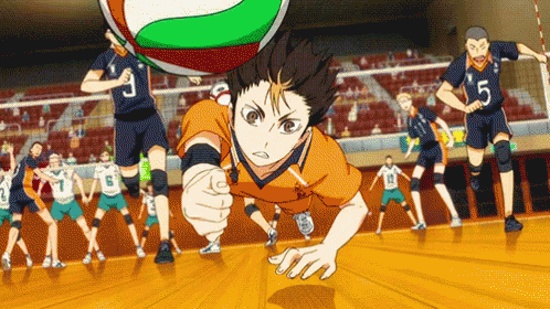 A Group Of Volleyball Players Are Playing Volleyball In A Stadium . GIF