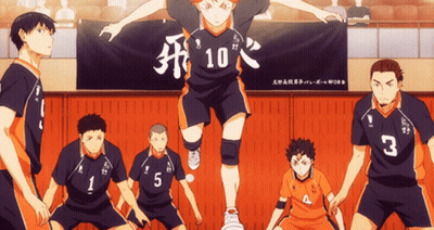 A Group Of Volleyball Players Are Standing In Front Of A Banner With The Number 10 On It GIF