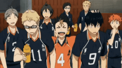 A Group Of Volleyball Players Are Standing Next To Each Other In A Gym . GIF