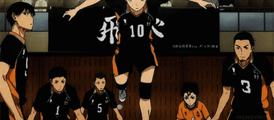 A Group Of Volleyball Players Are Standing Next To Each Other In Front Of A Banner With The Number 10 On It . GIF