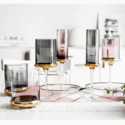 A Group Of Wine Glasses Sitting On Top Of A Table . GIF