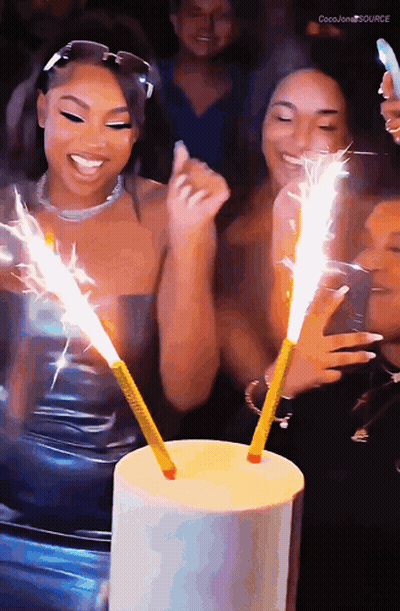 A Group Of Women Are Celebrating A Birthday With Sparklers And The Words Coco Jones Source In The Corner GIF