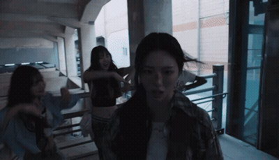 A Group Of Women Are Dancing In A Dark Room With The Number 11 In The Background GIF