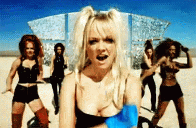 A Group Of Women Are Dancing In A Desert In A Video . GIF