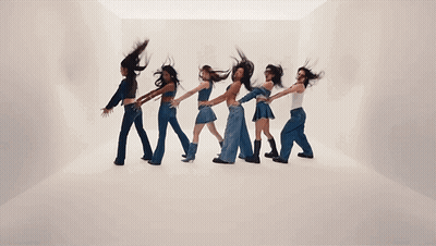 A Group Of Women Are Dancing In A Line With Their Hair Flying In The Air GIF