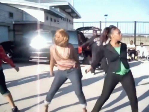 A Group Of Women Are Dancing In A Parking Lot And One Of Them Has The Number 8 On Her Shirt GIF