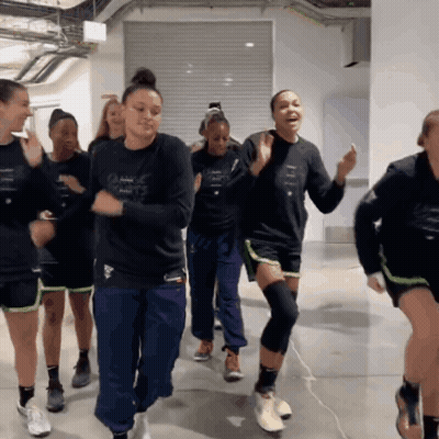A Group Of Women Are Dancing In A Room And One Of Them Has A Shirt That Says Adidas GIF