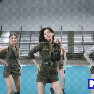 A Group Of Women Are Dancing In A Room With A Blue Rectangle In The Middle GIF
