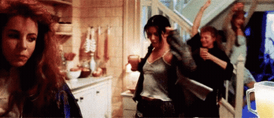 A Group Of Women Are Dancing In A Room With A Pitcher Of Beer In The Background . GIF
