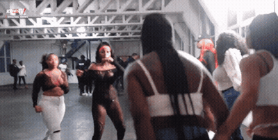 A Group Of Women Are Dancing In A Room With The Letters Kc On The Top GIF