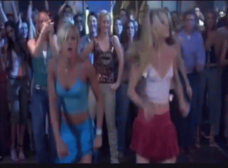 A Group Of Women Are Dancing In Front Of A Crowd Of People . GIF