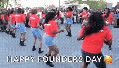 A Group Of Women Are Dancing In Front Of A Crowd . GIF
