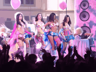 A Group Of Women Are Dancing In Front Of A Crowd With Balloons And Speakers GIF