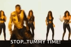 A Group Of Women Are Dancing In Front Of A Man Who Is Dancing . GIF