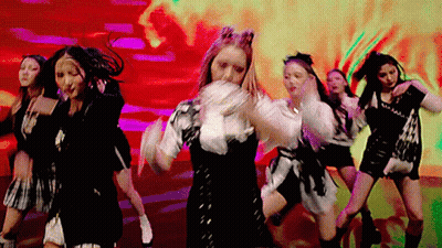 A Group Of Women Are Dancing In Front Of A Red Background . GIF