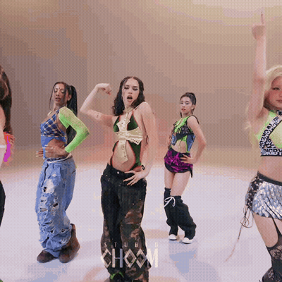 A Group Of Women Are Dancing In Front Of A Sign That Says ' Show ' GIF