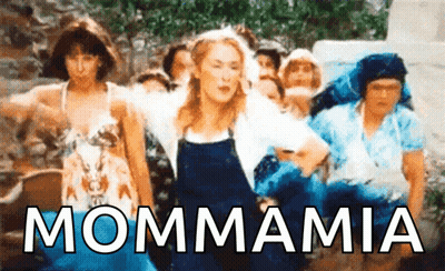A Group Of Women Are Dancing In Front Of The Word Mammamia GIF