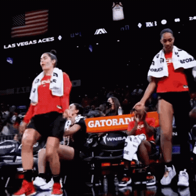 A Group Of Women Are Dancing On A Basketball Court In Front Of A Banner That Says Gatorade GIF