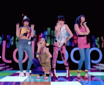 A Group Of Women Are Dancing On A Colorful Dance Floor With The Word Lollipop In The Background GIF