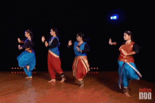 A Group Of Women Are Dancing On A Stage With The Word Indian On The Bottom Left GIF