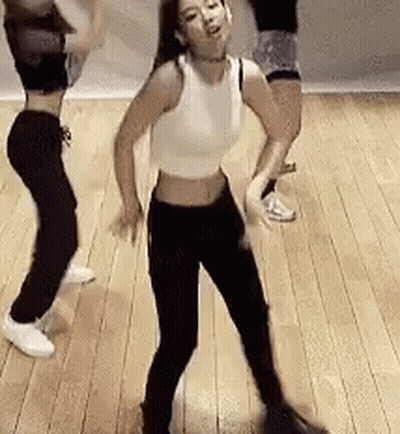 A Group Of Women Are Dancing On A Wooden Floor In A Room . GIF