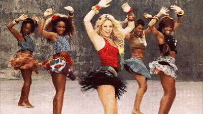 A Group Of Women Are Dancing Together And One Of Them Is Wearing A Red Tank Top . GIF