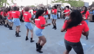 A Group Of Women Are Dancing Together In A Parking Lot . GIF