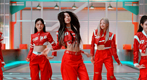 A Group Of Women Are Dancing Together In Red Outfits . GIF
