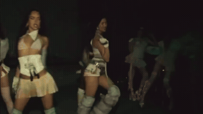 A Group Of Women Are Dancing Together In The Dark GIF