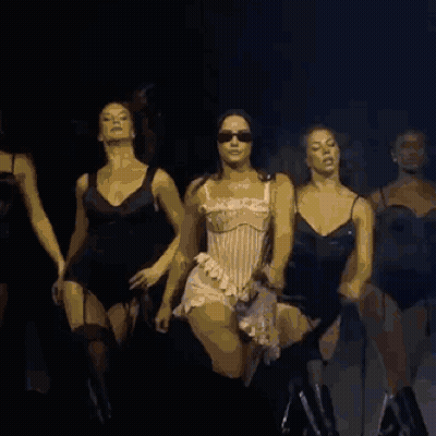 A Group Of Women Are Dancing Together On A Stage GIF
