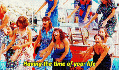 A Group Of Women Are Dancing Together With The Words `` Having The Time Of Your Life '' Written On The Bottom . GIF