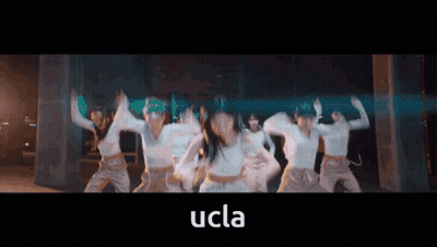 A Group Of Women Are Dancing With The Word Ucla In The Corner GIF
