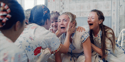 A Group Of Women Are Laughing And One Of Them Is Crying With Her Mouth Open GIF