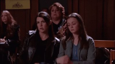A Group Of Women Are Sitting In A Room And One Of Them Is Holding A Cell Phone . GIF