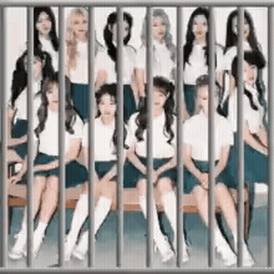 A Group Of Women Are Sitting On A Bench Behind Bars In A Jail Cell . GIF