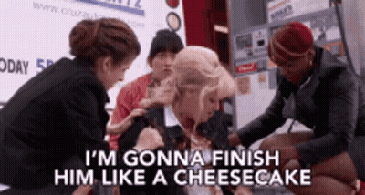 A Group Of Women Are Standing Around A Woman Who Says I 'M Gonna Finish Him Like A Cheesecake .. GIF