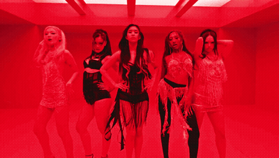 A Group Of Women Are Standing In A Room With Red Lights GIF